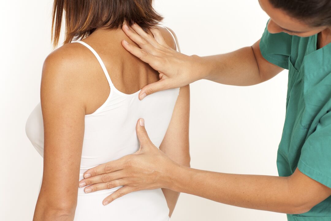 Doctor examining back with thoracic osteochondrosis